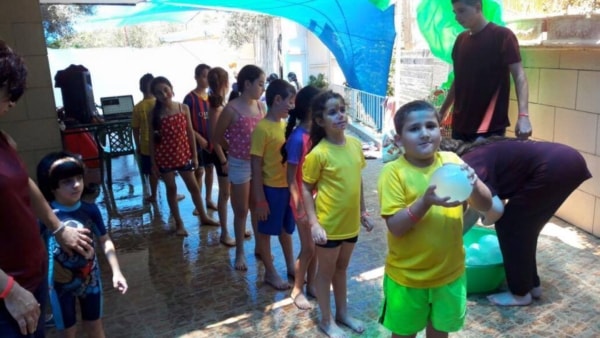 children playing with water balloons at a vbs
