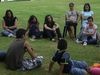 young people sitting on lawn