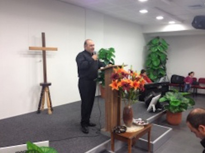 pastor hani preaching at the baptist church in cana