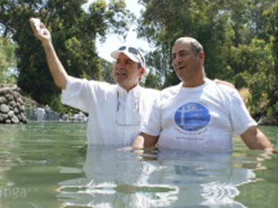 Pastor Suhail baptizing in the jordan river