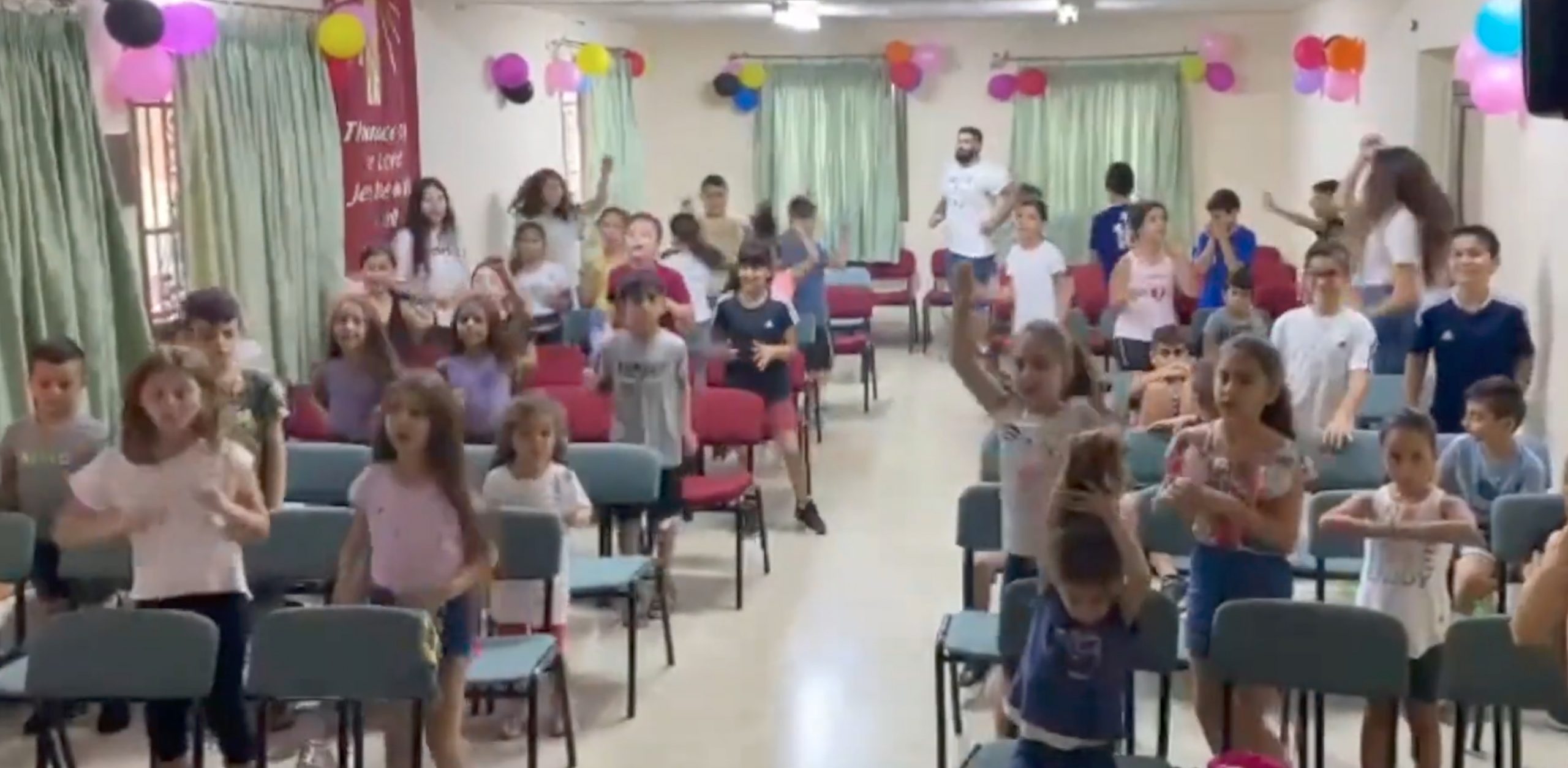 children singing songs at the vacation bible school at the baptist church in cana