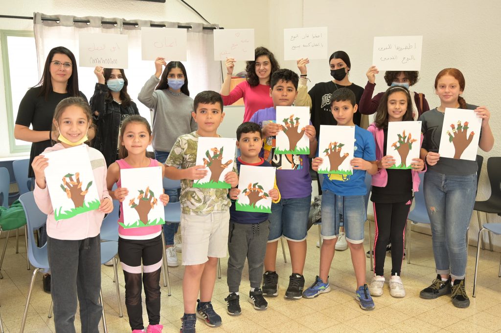 kinds taking a picture with the crafts they made