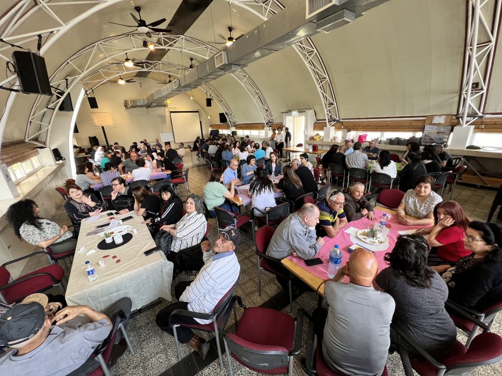 People sitting around tables at the ABC day