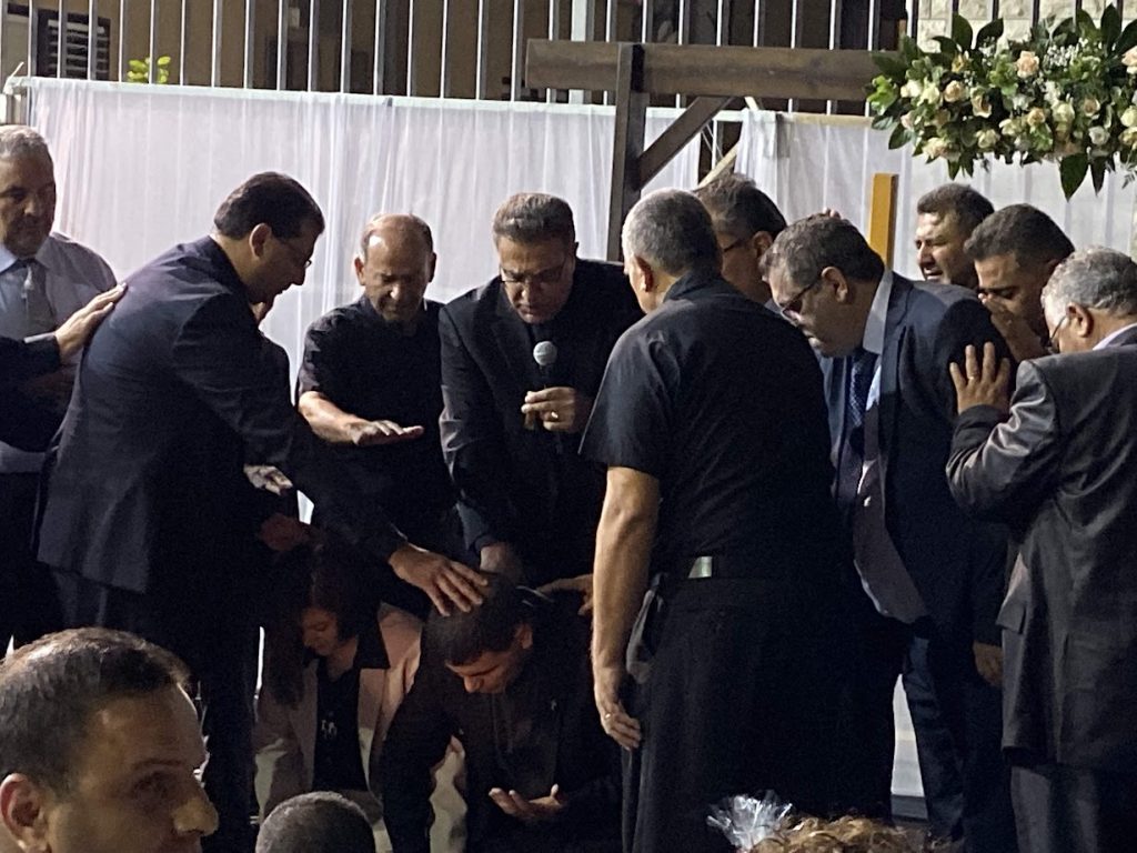 Brother Ziad and his wife being prayed over by all pastors present 
